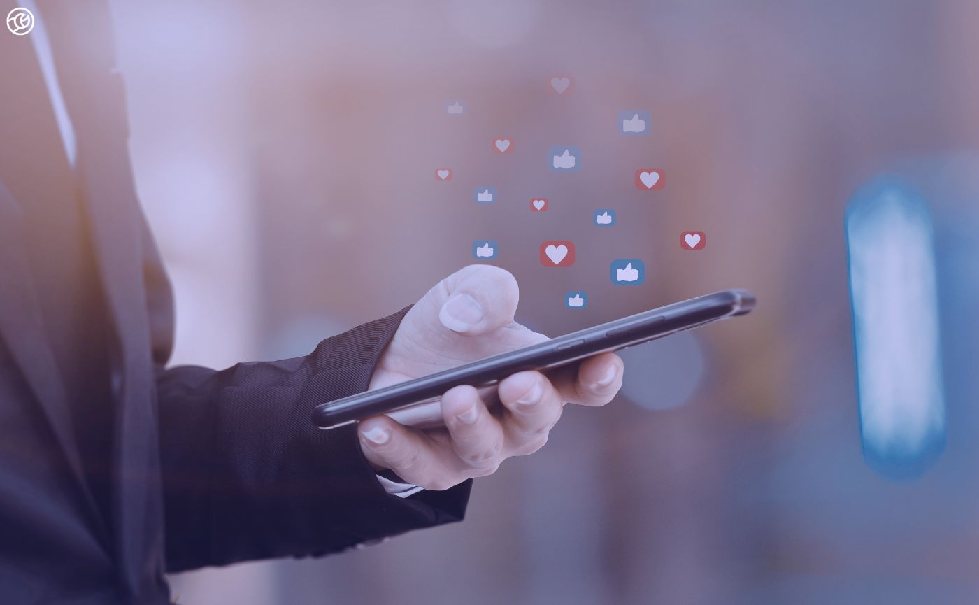 Person on smart phones with social media icons around the phone